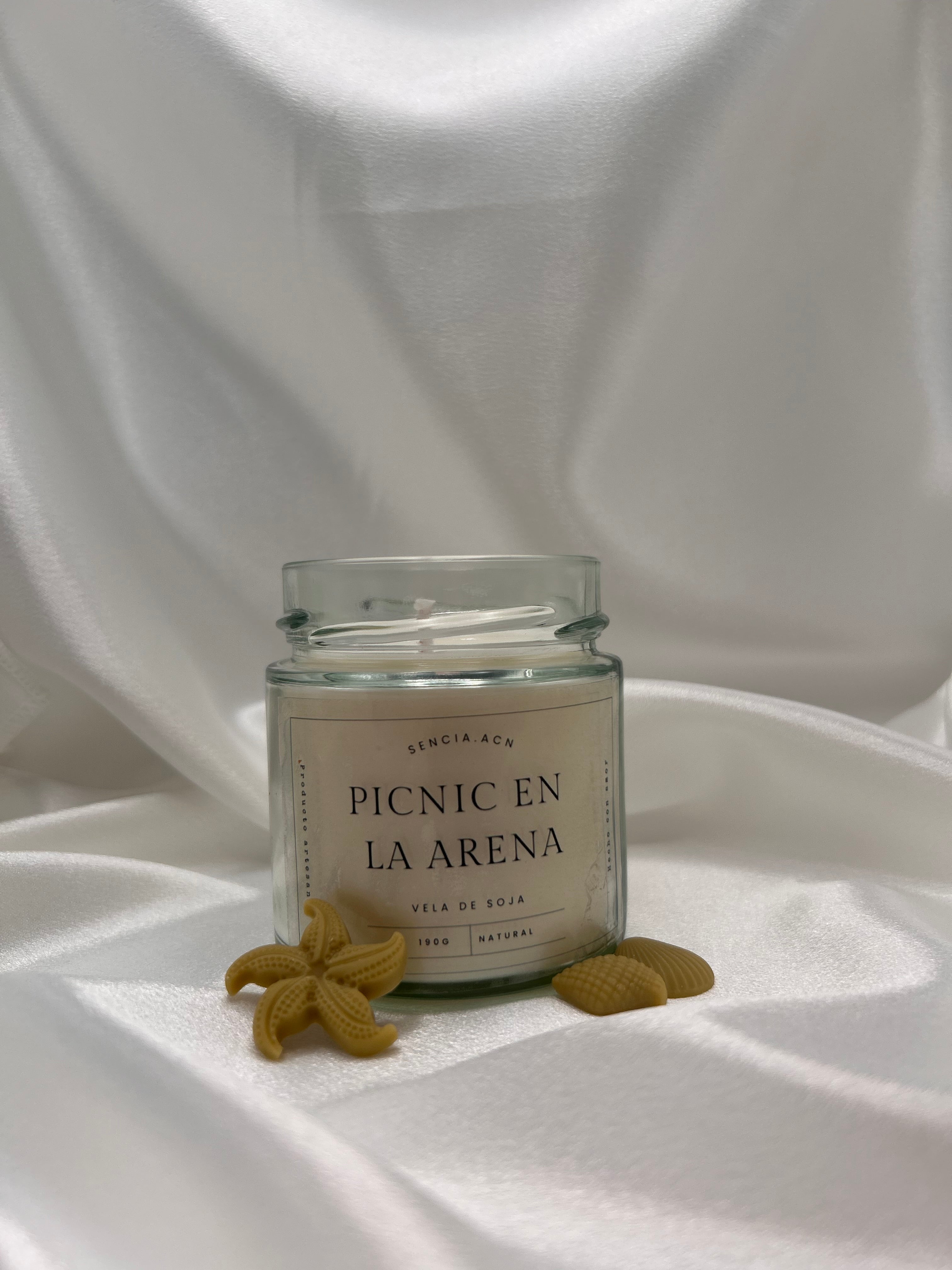 vela aromática picnic en la arena
